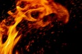 Flame fire with sparks on black background Royalty Free Stock Photo