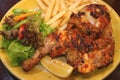 Flame grilled spicy chicken with chips and fresh salad
