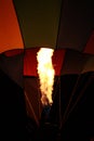 Flame heating a hot air balloon at night