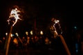 Flame on a homemade torch, fire on the background of night streets, peaceful actions with torches Royalty Free Stock Photo