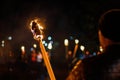 Flame on a homemade torch, fire on the background of night streets, peaceful actions with torches Royalty Free Stock Photo