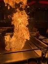 A flame leaps from the grill at a Tepanyaki Restaurant in Manchester, England