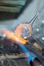 A flame and melting glass piece Royalty Free Stock Photo