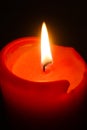 Flame of one white burning brightly wax  candle on the dark black background . Mourning candle. Isolated, close up. Lighting a can Royalty Free Stock Photo