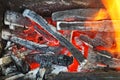 Flame over hot wood-burning coals Royalty Free Stock Photo