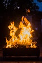 Flame rising from burning charcoal and wood in a mangal