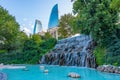 Flame towers viewed behind waterfall at selale park in Baku, Aze