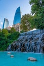 Flame towers viewed behind waterfall at selale park in Baku, Aze