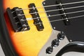 Flamed bass guitar detail with pickups and strings