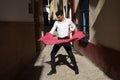 Flamenco and gipsy man, dressed in black and white shirt dancing with a polka-dotted handkerchief in his hand in an alley in the Royalty Free Stock Photo