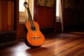 flamenco guitar resting on a wooden floor