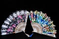 Flamenco hand fan with colorful pattern isolated on black background