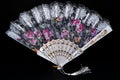 Flamenco hand fan with colorful pattern isolated on black background Royalty Free Stock Photo