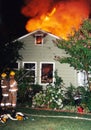 Flames come through the roof at a house fire