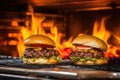 flames dance under burgers under grill light