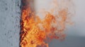 Flames Engulfing A Wall With Intense Orange Fire. Fire Safety And Emergency Response Concept Royalty Free Stock Photo