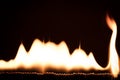 Flames and fire in front of black, lots of matches burning Royalty Free Stock Photo