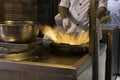 Fire and Food a chinese chef prepares food in a wok