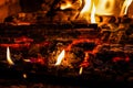Flames of fire and hot coals of burned wood in the fireplace Royalty Free Stock Photo