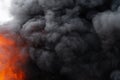 Flames of red fire and motion blur clouds of black smoke covered sky Royalty Free Stock Photo