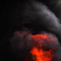 Flames of red fire and motion blur dramatic clouds of black smoke covered sky Royalty Free Stock Photo