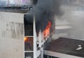 Flames and smoke rise from burning building