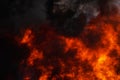 Flames strong industrial red fire, dramatic clouds of black smoke covered sky Royalty Free Stock Photo