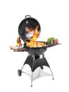 Flaming barbecue grill with cooking meal on background Royalty Free Stock Photo