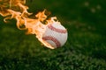 Flaming baseball ball on fire flying through the air, illustrating intense sports action Royalty Free Stock Photo