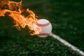 Flaming baseball ball on fire flying through the air, illustrating intense sports action Royalty Free Stock Photo