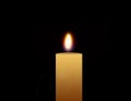 Flaming candle isolated on a black background Royalty Free Stock Photo