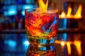 flaming cocktail with colorful reflections on glass surface