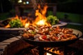 flaming grill with sizzling shrimp in backyard setting