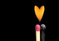 Flaming heart made by two burning matchsticks Royalty Free Stock Photo