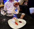 Waiter pouring flambe over meringue ice cream dessert. Royalty Free Stock Photo