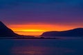 Colorful midsummer sky in orange, yellow and violet at Norwegian Sea, North Norway, Flaming sunset.