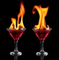 Flaming red cocktails over black Royalty Free Stock Photo