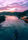 Boat shipping in river under Amazing flaming red fire clouds