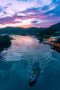 Boat shipping in river under Amazing flaming red fire clouds