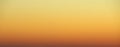 Flaming sky over the horizon during sunset or sunrise. Bright iridescent colors of yellow, orange and red. Colored background for Royalty Free Stock Photo