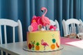 Flamingo cake at the Hawaiian party. Childrens birthday cake aon the table