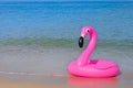 Flamingo shape, floating rubber ring by the beach