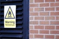 Flammable gas safety warning sign on Louvre door of plant room Royalty Free Stock Photo