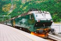 Flamsbahn In Flam, Norway. Green Train On Railway