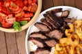 Flank steak with fries onion rings and salad Royalty Free Stock Photo