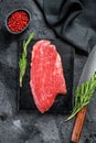 Flank steak. Raw Marble beef meat black Angus. Black background. Top view Royalty Free Stock Photo