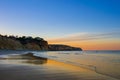 Flanked by tall cliffs, the lovely Porto de MÃÂ³s Beach is like a long tongue of golden sand. In Lagos,Western Algarve coastline,