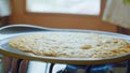 Flapjack, tortilla, pizza, bake fry pan cake on gas stove. Close up. Side view.