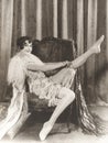 Flapper rolling up stockings Royalty Free Stock Photo