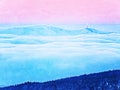 . Pink orange sun rise above misty winter mountains, shinning fog. Peaks of mountains Royalty Free Stock Photo